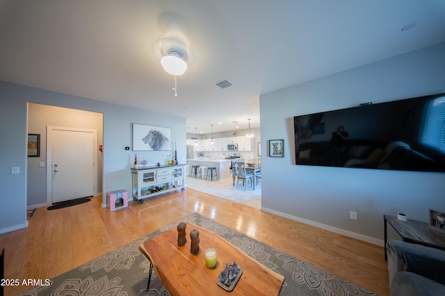 2361 N 212th Dr, Buckeye, AZ 85396 - living room with light wood-style floors and ceiling fan