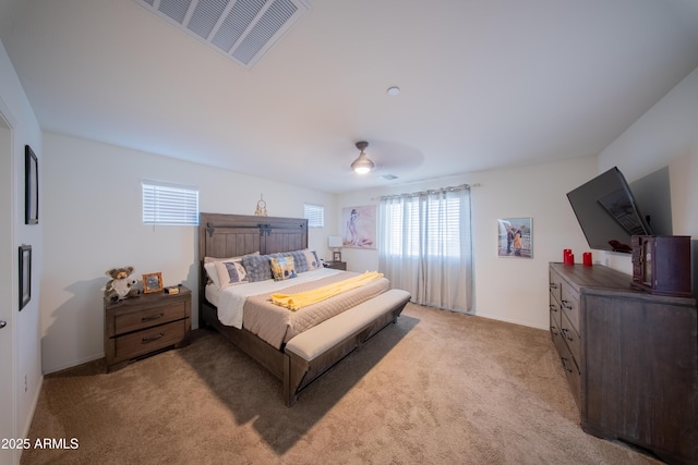 2361 N 212th Dr, Buckeye, AZ 85396 - bedroom with multiple windows, light carpet, and a ceiling fan