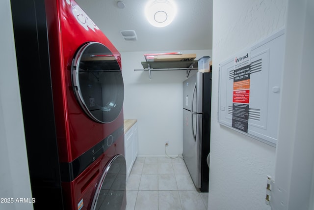 2361 N 212th Dr, Buckeye, AZ 85396 - laundry room featuring stacked washer / dryer and light tile patterned flooring