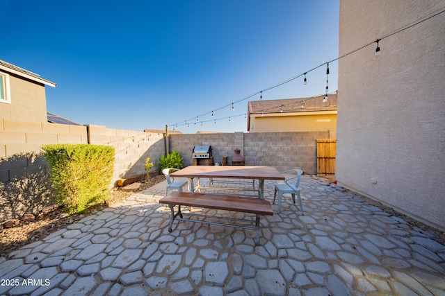 2361 N 212th Dr, Buckeye, AZ 85396 - fenced backyard with outdoor dining area, a patio, and a grill