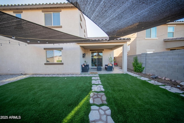 2361 N 212th Dr, Buckeye, AZ 85396 - rear view of property with a fenced backyard, a patio area, an outdoor hangout area, and stucco siding