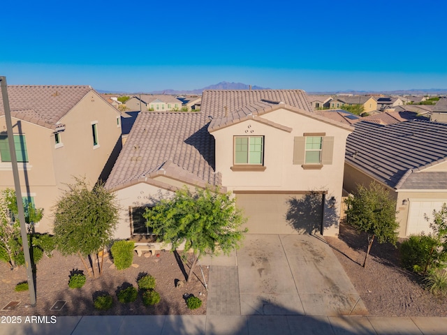 2361 N 212th Dr, Buckeye, AZ 85396 - mediterranean / spanish house with a residential view, concrete driveway, stucco siding, and an attached garage