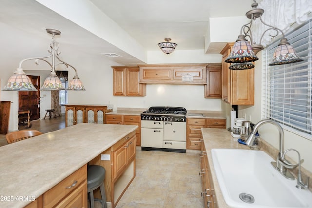 1170 N Broken Wagon Trl, Dewey, AZ 86327 - kitchen featuring a sink, light countertops, white gas range, and pendant lighting