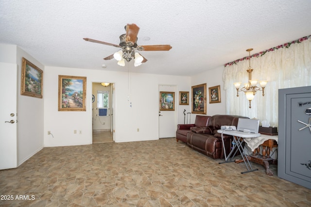 1170 N Broken Wagon Trl, Dewey, AZ 86327 - living area with stone finish floors, a chandelier, a ceiling fan, and a textured ceiling