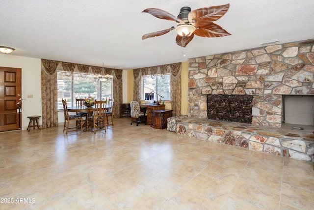 1170 N Broken Wagon Trl, Dewey, AZ 86327 - living area with ceiling fan, a fireplace, and a textured ceiling