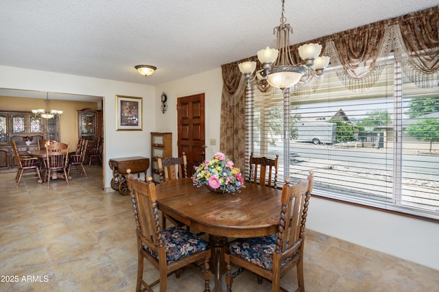 1170 N Broken Wagon Trl, Dewey, AZ 86327 - dining area featuring a chandelier, plenty of natural light, and a textured ceiling