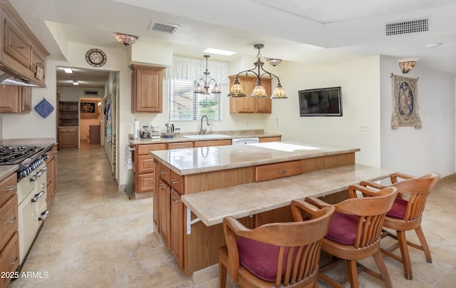 1170 N Broken Wagon Trl, Dewey, AZ 86327 - kitchen featuring a sink, a kitchen island, cooktop, light countertops, and stone finish floors