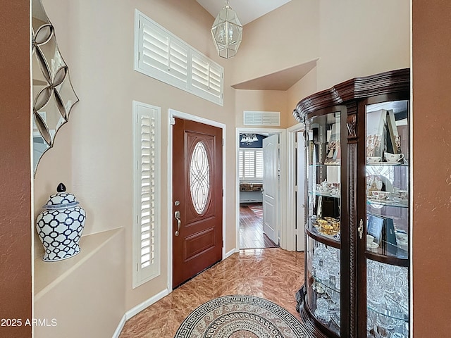 1350 E Racine Dr, Casa Grande, AZ 85122 - foyer entrance featuring a notable chandelier, visible vents, a high ceiling, and baseboards