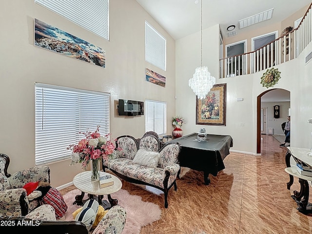 1350 E Racine Dr, Casa Grande, AZ 85122 - living area featuring visible vents, baseboards, arched walkways, and a chandelier