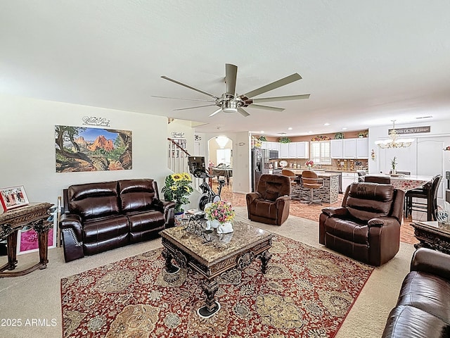 1350 E Racine Dr, Casa Grande, AZ 85122 - living room featuring light carpet and ceiling fan with notable chandelier