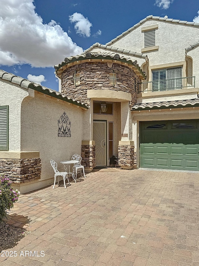 1350 E Racine Dr, Casa Grande, AZ 85122 - view of front of home with a tiled roof, stucco siding, stone siding, and a balcony