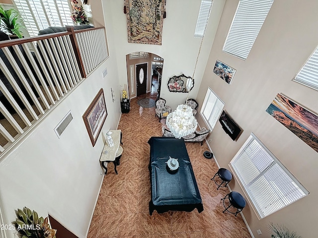1350 E Racine Dr, Casa Grande, AZ 85122 - living area featuring arched walkways, a towering ceiling, and visible vents