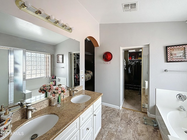 1350 E Racine Dr, Casa Grande, AZ 85122 - full bath featuring a spacious closet, a bath, visible vents, and a sink