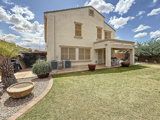 1350 E Racine Dr, Casa Grande, AZ 85122 - back of house featuring a yard, a patio area, stucco siding, and fence