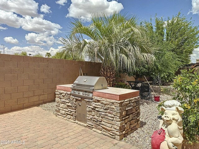 1350 E Racine Dr, Casa Grande, AZ 85122 - view of patio with exterior kitchen, a fenced backyard, and area for grilling