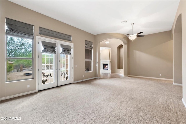 unfurnished living room with light carpet and ceiling fan