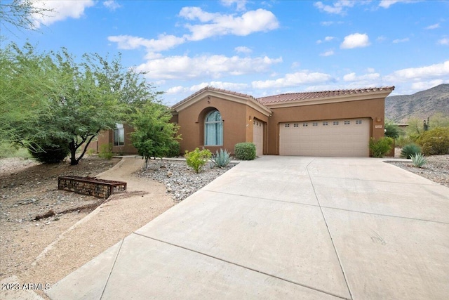 view of front facade featuring a mountain view and a garage