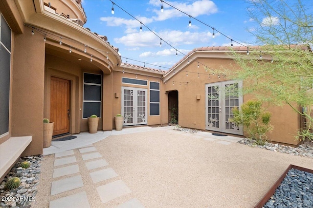 back of property featuring french doors and a patio area