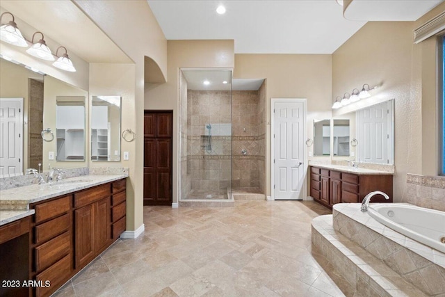 bathroom with vanity and separate shower and tub