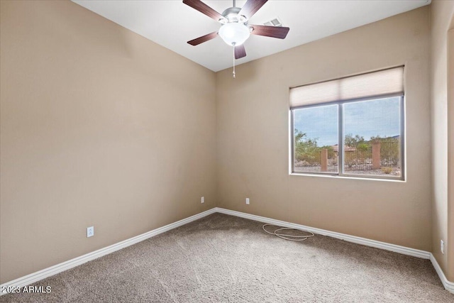 spare room featuring ceiling fan and carpet floors