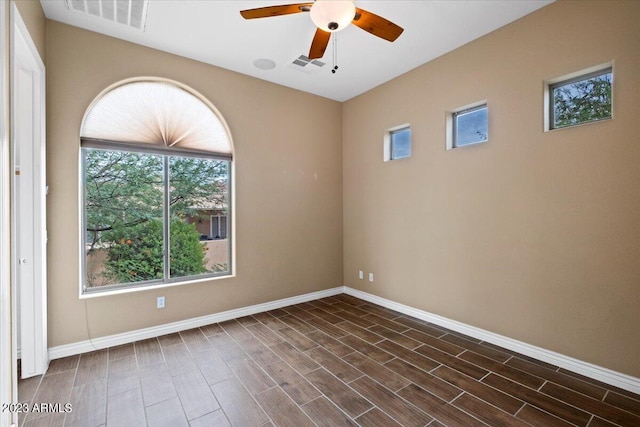 unfurnished room with dark hardwood / wood-style flooring and ceiling fan