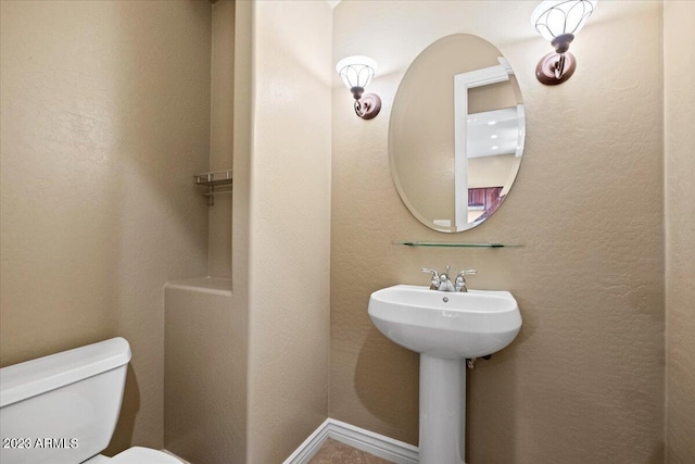 bathroom featuring sink and toilet