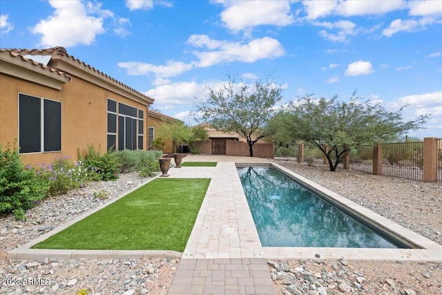 view of pool with a lawn