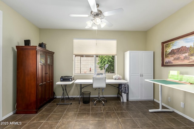 office area with ceiling fan and dark tile patterned floors