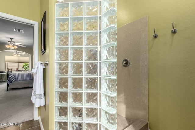 bathroom featuring walk in shower and ceiling fan