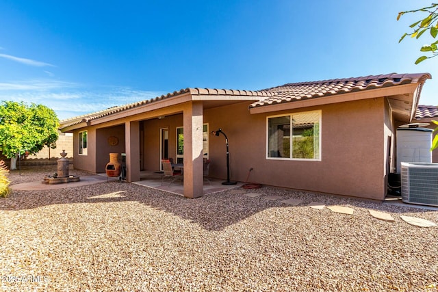 back of property featuring central AC unit and a patio area