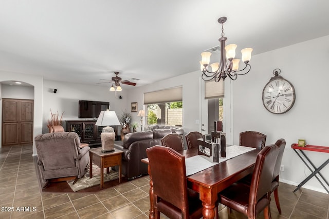 tiled dining area with ceiling fan with notable chandelier