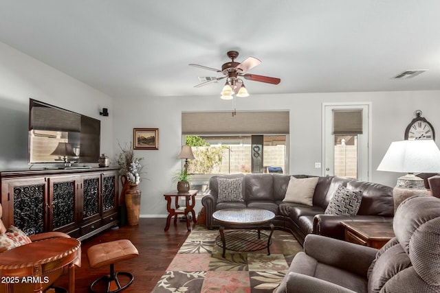 living room featuring dark hardwood / wood-style floors and ceiling fan