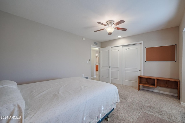 bedroom with ceiling fan, a closet, and carpet floors