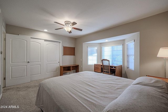 bedroom with light carpet, a closet, and ceiling fan