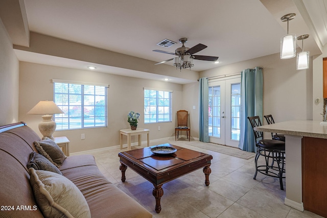 living room with ceiling fan, french doors, and light tile patterned floors