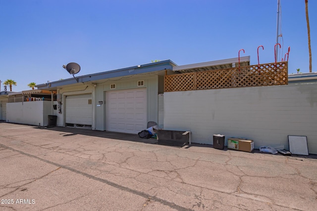 rear view of property featuring fence