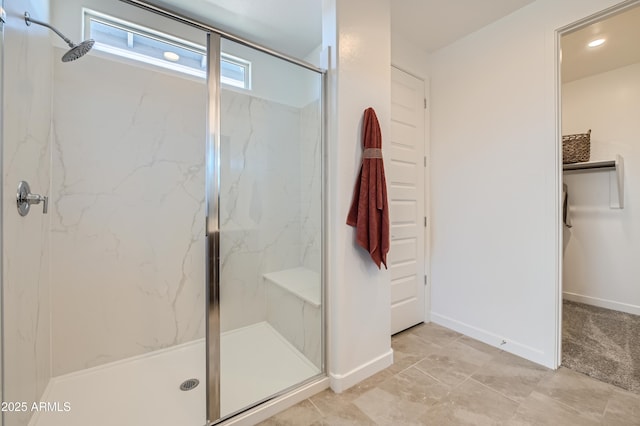 full bathroom featuring recessed lighting, baseboards, and a marble finish shower