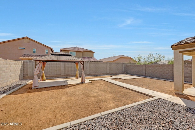 view of yard featuring a fenced backyard, a gazebo, and a patio area