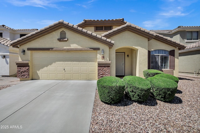 23862 W Chambers St, Buckeye, AZ 85326 - view of front of home featuring stone siding, concrete driveway, a garage, and stucco siding