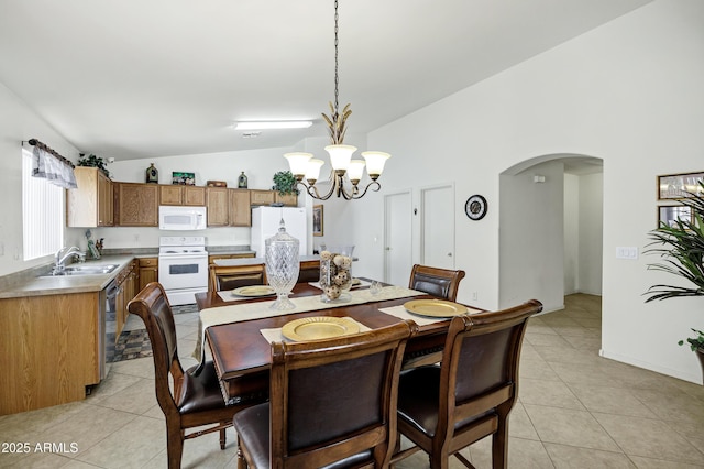 23862 W Chambers St, Buckeye, AZ 85326 - dining space with vaulted ceiling, arched walkways, light tile patterned floors, and a chandelier