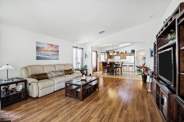 23862 W Chambers St, Buckeye, AZ 85326 - living room featuring vaulted ceiling, wood finished floors, and a chandelier