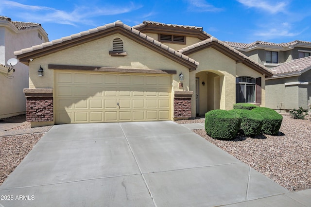 23862 W Chambers St, Buckeye, AZ 85326 - mediterranean / spanish-style house featuring stone siding, an attached garage, driveway, and a tiled roof