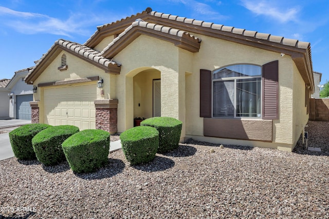 23862 W Chambers St, Buckeye, AZ 85326 - mediterranean / spanish house featuring a garage, stucco siding, and a tile roof