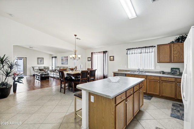23862 W Chambers St, Buckeye, AZ 85326 - kitchen featuring vaulted ceiling, freestanding refrigerator, a chandelier, light tile patterned floors, and light countertops