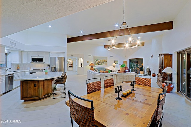 tiled dining room featuring a textured ceiling, high vaulted ceiling, sink, beamed ceiling, and a chandelier