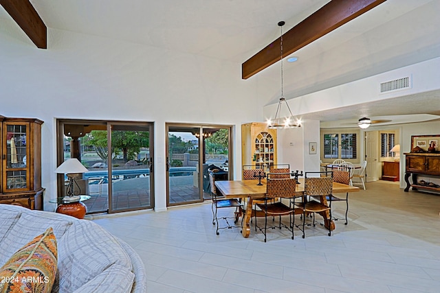 tiled dining room with beamed ceiling, high vaulted ceiling, and ceiling fan with notable chandelier