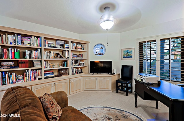 office with ceiling fan and light hardwood / wood-style flooring