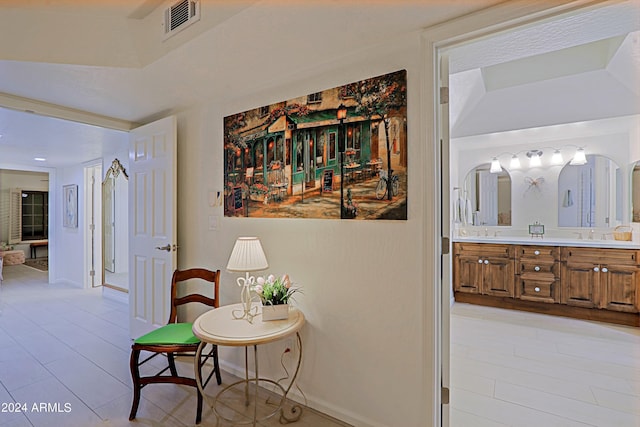 hallway with light tile patterned flooring and sink