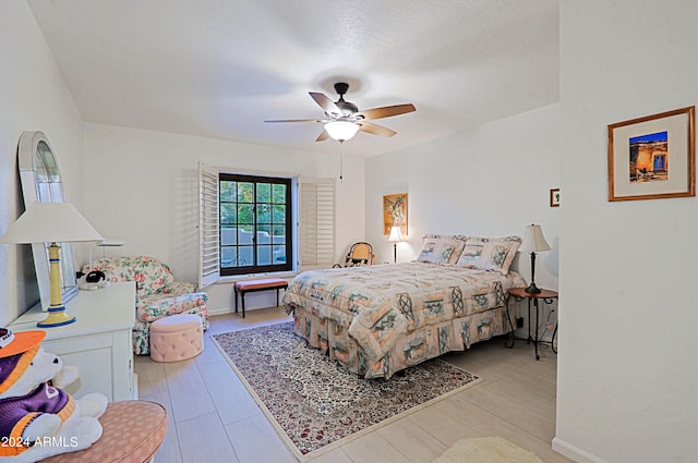 bedroom with light wood-type flooring and ceiling fan