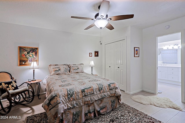 bedroom featuring a closet, light tile patterned floors, ceiling fan, and ensuite bath